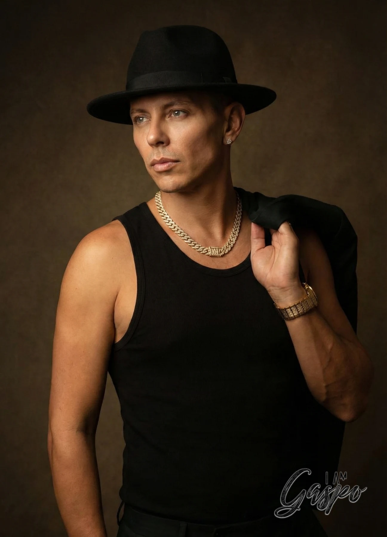 Editorial male portrait with black hat and jewelry
